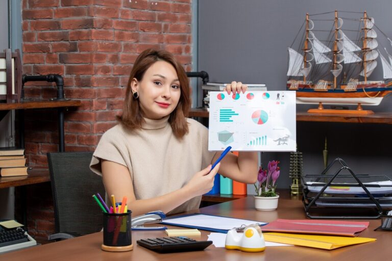 front-view-pretty-woman-showing-diagrams-working-office_140725-109240