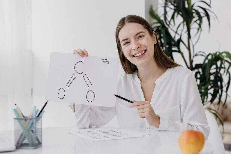 front-view-woman-holding-chemistry-drawing_23-2148771414
