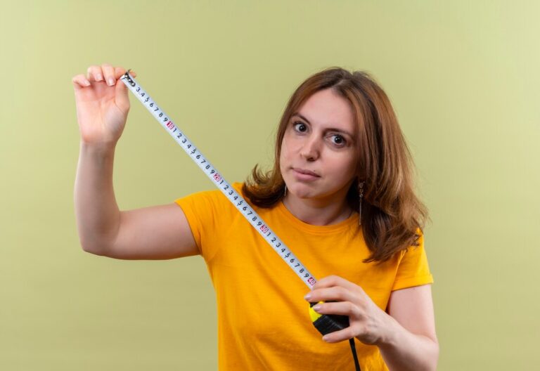 young-casual-woman-holding-tape-meter-isolated-green-wall_141793-79382