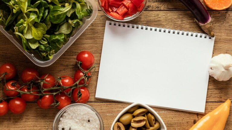 top-view-food-ingredients-with-notebook-vegetables_23-2148834777